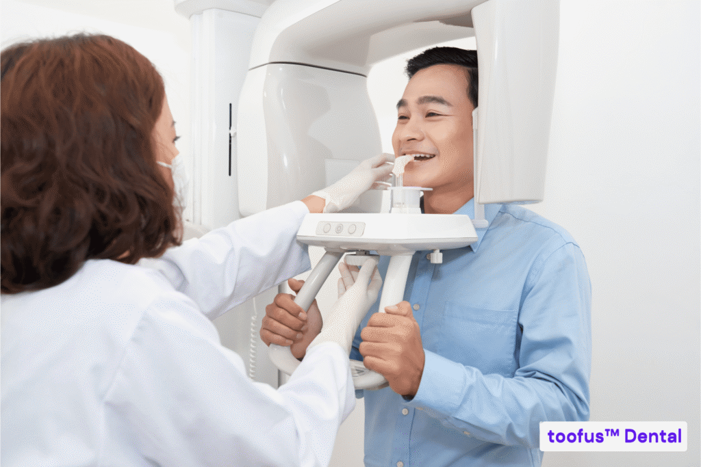 What Will Happen At Your First Dental Implant Consultation 1 Male patient doing a dental x-ray - toofus™ Dental